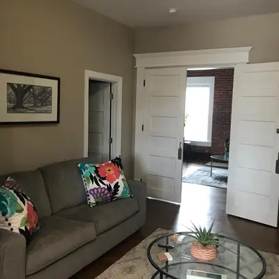a living room with a couch and a glass table at Big Brick 2 Bedroom apartment in Victorian Village in Columbus