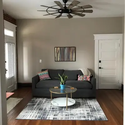 a living room with a couch and a table at Big Brick 2 Bedroom apartment in Victorian Village in Columbus