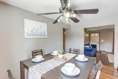 a dining room with a table and a ceiling fan at Lake Erie Family Getaway in Amherst Pets Welcome! in Amherst