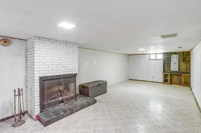 an empty room with a fireplace in the middle at Lake Erie Family Getaway in Amherst Pets Welcome! in Amherst