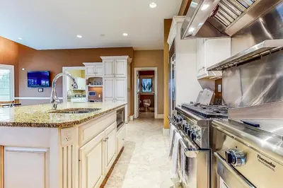 a large kitchen with a sink and a stove at The Estate House-Timeless Elegance at 1885 Farms in Navarre