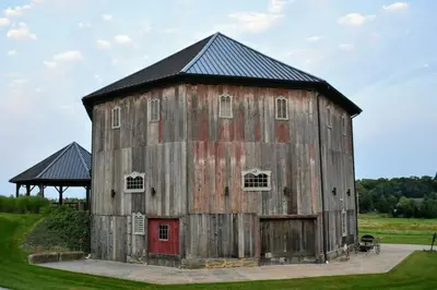an old wooden barn with a red door at The Estate House-Timeless Elegance at 1885 Farms in Navarre