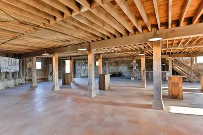 an empty building with wooden ceilings and wooden pillars at The Estate House-Timeless Elegance at 1885 Farms in Navarre