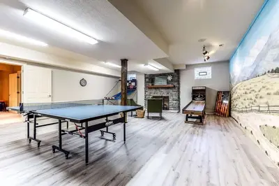 a room with a ping pong table in it at The Estate House-Timeless Elegance at 1885 Farms in Navarre