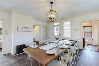 a dining room with a large wooden table and chairs at The Farmhouse at 1885-Where Past Meets Present in Navarre