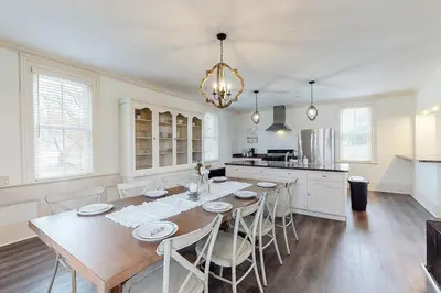 a dining room with a table and chairs in a kitchen at The Farmhouse at 1885-Where Past Meets Present in Navarre