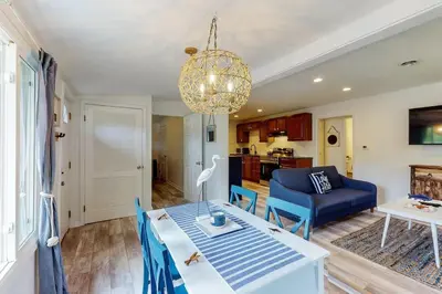 a living room with a table and a blue couch at Atwood Breeze-Tranquil Lake Escape in Sherrodsville