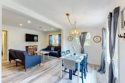 a living room with a blue couch and a table at Atwood Breeze-Tranquil Lake Escape in Sherrodsville
