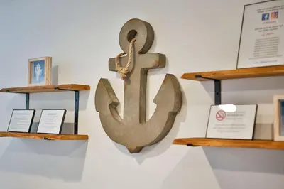 a metal anchor on a wall with wooden shelves at Atwood Breeze-Tranquil Lake Escape in Sherrodsville