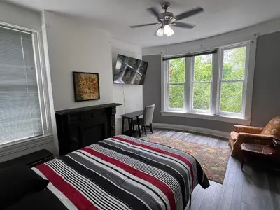 a bedroom with a bed and a ceiling fan at Second floor deluxe studio in Cincinnati