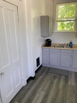a kitchen with white cabinets and a sink and a window at Second floor deluxe studio in Cincinnati