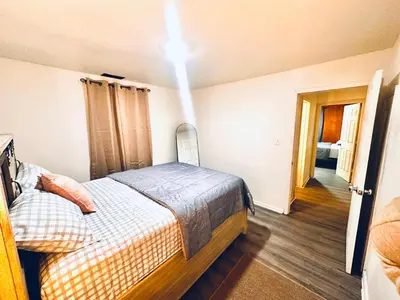 a bedroom with a bed and a light on the ceiling at Cozy Muncie Home Near Downtown in Muncie