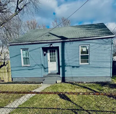 a blue house with a white door at Cozy Muncie Home Near Downtown in Muncie