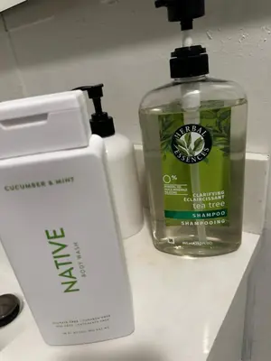 a bottle of mouthwash and a soap dispenser on a counter at Cozy Muncie Home Near Downtown in Muncie
