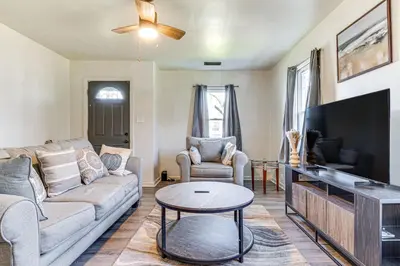 a living room with a couch and a tv at Cozy Muncie Home Near Downtown in Muncie