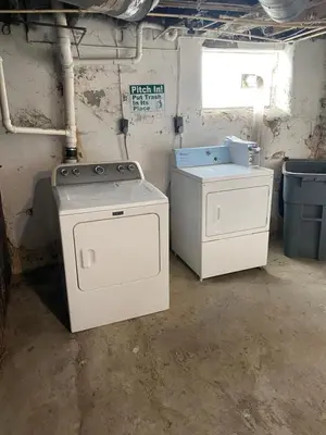 a laundry room with a stove and a washer and dryer at Second floor petite studio private room in Cincinnati