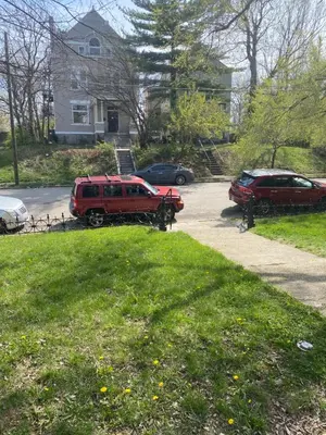 a couple of cars parked in a driveway at Second floor petite studio private room in Cincinnati