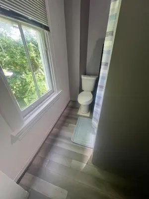 a bathroom with a toilet and a window at Second floor petite studio private room in Cincinnati
