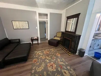 a living room with a couch and a fireplace at Second floor standard studio private room in Cincinnati