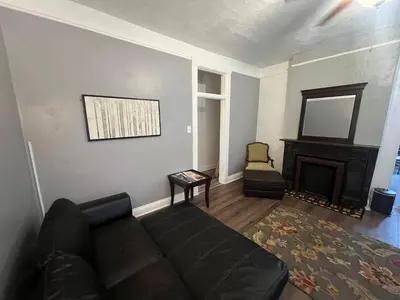 a living room with a couch and a fireplace at Second floor standard studio private room in Cincinnati