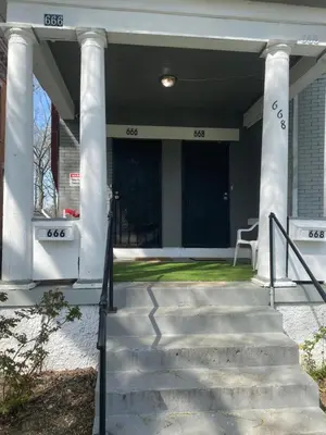 a white house with columns and a staircase at Second floor standard studio private room in Cincinnati