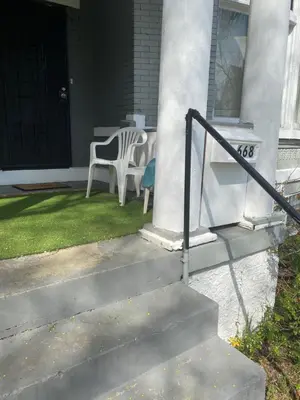 a porch with a table and chairs on a house at Second floor standard studio private room in Cincinnati