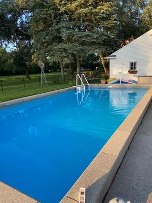 a swimming pool with blue water in a yard at The Vine Bed & Breakfast, LLC in Dundee