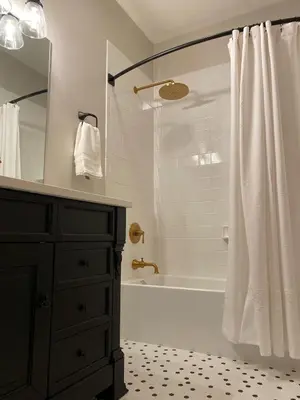 a bathroom with a tub and a shower with a curtain at The Vine Bed & Breakfast, LLC in Dundee