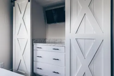 a bedroom with a closet with a sliding door at Cincinnati Camp Cedar in Mason