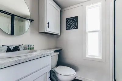 a bathroom with a sink and a toilet and a mirror at Cincinnati Camp Cedar in Mason
