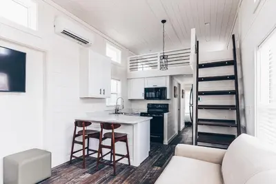 a kitchen and living room with a couch and a counter at Cincinnati Camp Cedar in Mason