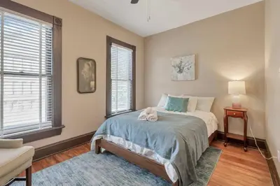 a bedroom with a bed and two windows at 4 Bed Duplex near Goodale Park in Columbus