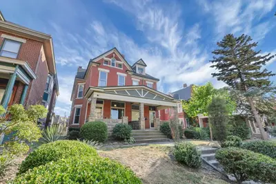 a large red brick house with a tree at 4 Bed Duplex near Goodale Park in Columbus