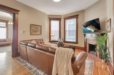 a living room with a leather couch and a fireplace at 4 Bed Duplex near Goodale Park in Columbus