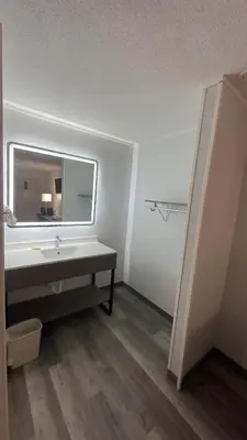 a bathroom with a sink and a mirror at Botkins Motel