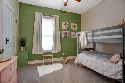 a bedroom with green walls and a bunk bed at General Mitchel Historic Home in Downtown Lebanon in Lebanon