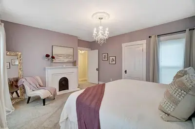 a bedroom with a large bed and a fireplace at General Mitchel Historic Home in Downtown Lebanon in Lebanon