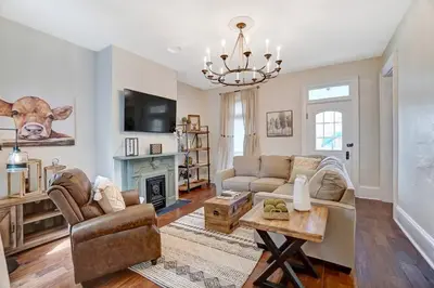 a living room with a cow head on the wall at General Mitchel Historic Home in Downtown Lebanon in Lebanon