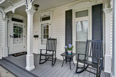 two chairs and a table on the porch of a house at General Mitchel Historic Home in Downtown Lebanon in Lebanon