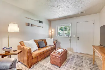 a living room with a couch and a table at Cozy Meyers Lake Townhome Near Hall of Fame! in Canton