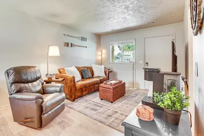 a living room with a couch and a chair at Cozy Meyers Lake Townhome Near Hall of Fame! in Canton