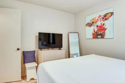 a bedroom with a bed and a flat screen tv at Cozy Meyers Lake Townhome Near Hall of Fame! in Canton