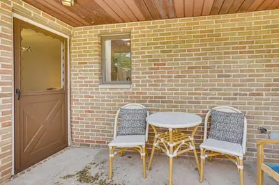 a patio with a table and two chairs and a door at Cozy Meyers Lake Townhome Near Hall of Fame! in Canton