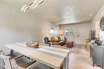 a living room with a table and a couch at Cozy Meyers Lake Townhome Near Hall of Fame! in Canton