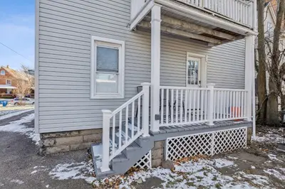 a house with a white staircase on the side of it at Tiny Taco House in Lakewood