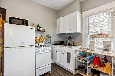 a kitchen with white appliances and a white refrigerator at Tiny Taco House in Lakewood