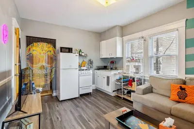 a living room with a couch and a kitchen at Tiny Taco House in Lakewood