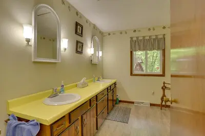 a bathroom with a sink and a mirror at Peaceful Carrollton Retreat with Deck and Fire Pit! in Carrollton