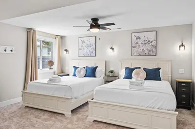 two white beds in a bedroom with a ceiling fan at Home for 21 Near Ark - Ensuite Bathrooms - with Pool! in Williamstown