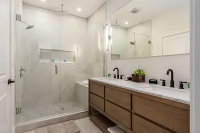 a bathroom with a shower and a sink and a tub at Stylish 4BR in Merion Village PD in Columbus